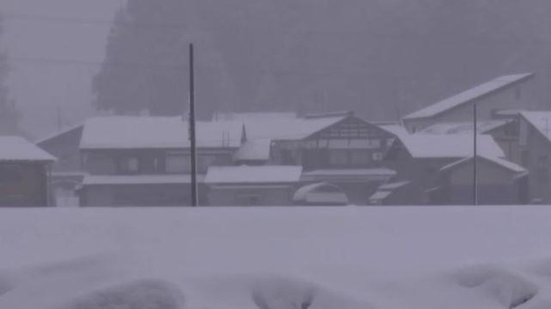 A man clears snow at a parking lot in Kitami, Hokkaido Prefecture, Japan in this photo taken by Kyodo on December 24, 2022.  Mandatory credit Kyodo/via REUTERS ATTENTION EDITORS - THIS IMAGE WAS PROVIDED BY A THIRD PARTY. MANDATORY CREDIT. JAPAN OUT. NO COMMERCIAL OR EDITORIAL SALES IN JAPAN