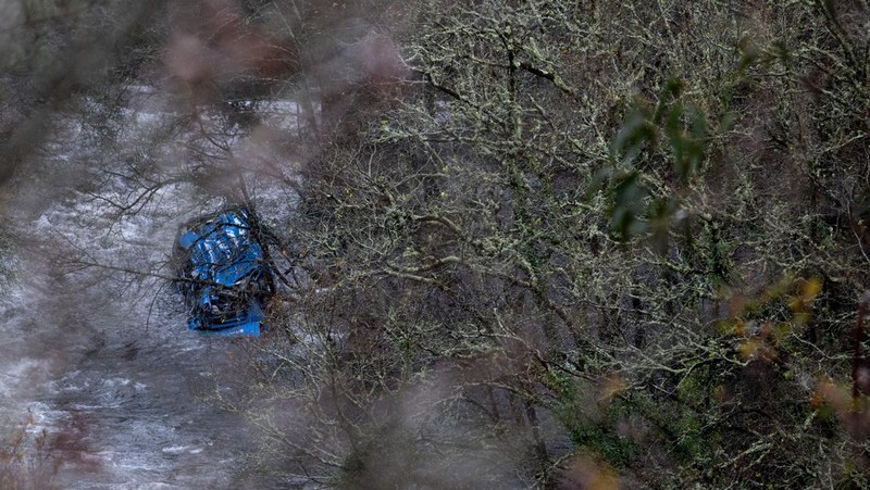 Bangkai bus terletak di sungai Lerez setelah jatuh saat melintasi jembatan, menewaskan empat orang, di Cerdedo-Cotobade, Spanyol barat laut, pada 25 Desember 2022. - Kecelakaan itu terjadi pada 24 Desember malam di dekat Vigo dan perbatasan dengan Portugal. Surat kabar regional La Voz de Galicia mengatakan bus itu membawa orang-orang yang mengunjungi orang yang mereka cintai yang dipenjara di Monterroso di Galicia tengah. Operasi penyelamatan harus dihentikan semalam karena cuaca buruk tetapi dilanjutkan di pagi hari. (BRAIS LORENZO/AFP via Getty Images)