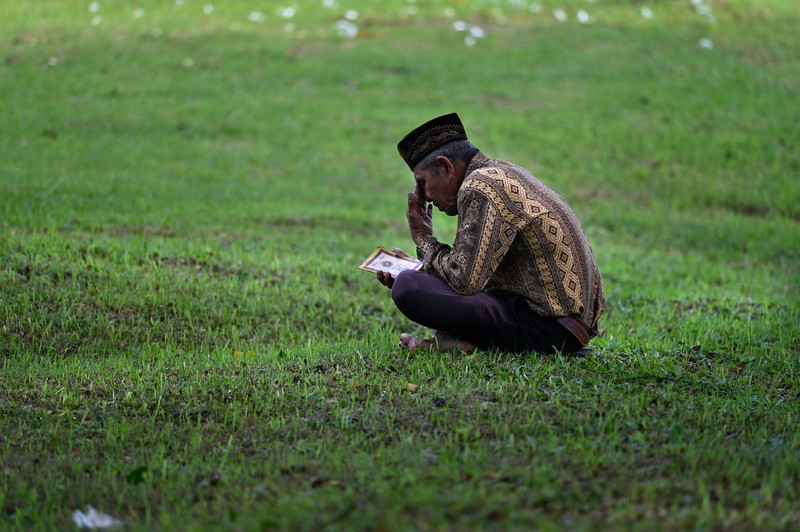 Seorang wanita berdoa di kuburan massal korban untuk memperingati 18 tahun tsunami Boxing Day 2004, di Banda Aceh pada 26 Desember 2022. Seorang wanita berdoa di kuburan massal korban untuk memperingati 18 tahun tsunami Boxing Day 2004, di Banda Aceh pada 26 Desember 2022. (PCHAIDEER MAHYUDDIN / AFP)