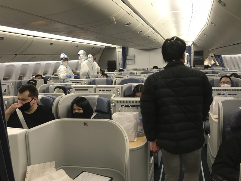 Pelancong yang masuk menunggu berjam-jam untuk naik bus untuk berangkat ke hotel dan fasilitas karantina dari Bandara Guangzhou Baiyun di provinsi Guangdong, China selatan pada 25 Desember 2022. China akan mencabut persyaratan karantina COVID-19 untuk penumpang yang datang dari luar negeri mulai 8 Januari 2020. Komisi Kesehatan Nasional mengumumkan pada Senin, 26 Desember 2022 dalam pelonggaran terbaru dari langkah-langkah pengendalian virus yang dulu ketat di negara itu. (AP Photo/Emily Wang Fujiyama)