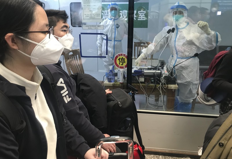 Pelancong yang masuk menunggu berjam-jam untuk naik bus untuk berangkat ke hotel dan fasilitas karantina dari Bandara Guangzhou Baiyun di provinsi Guangdong, China selatan pada 25 Desember 2022. Pelancong yang masuk menunggu berjam-jam untuk naik bus untuk berangkat ke hotel dan fasilitas karantina dari Bandara Guangzhou Baiyun di provinsi Guangdong, China selatan pada 25 Desember 2022. China akan mencabut persyaratan karantina COVID-19 untuk penumpang yang datang dari luar negeri mulai 8 Januari 2020. Komisi Kesehatan Nasional mengumumkan pada Senin, 26 Desember 2022 dalam pelonggaran terbaru dari langkah-langkah pengendalian virus yang dulu ketat di negara itu. (AP Photo/Emily Wang Fujiyama)
