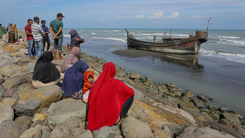 Foto yang diambil pada 26 Desember 2022 ini memperlihatkan para pria Rohingya sedang beristirahat di sebuah penampungan di distrik Muara Tiga di Pidie, provinsi Aceh. - Pengungsi Rohingya menerima perawatan medis darurat setelah sebuah kapal yang membawa hampir 200 orang mendarat di Indonesia pada 26 Desember, kata pihak berwenang, dalam pendaratan keempat di negara tersebut dalam beberapa bulan terakhir. (AMANDA JUFRIAN/AFP via Getty Images)