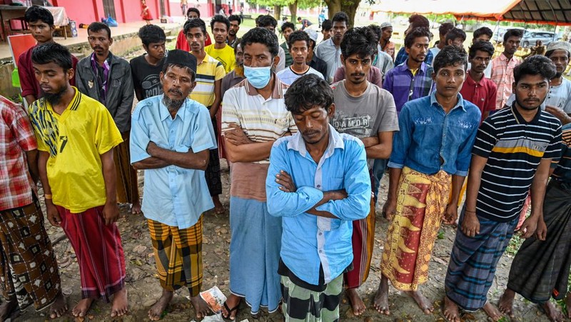 Foto yang diambil pada 26 Desember 2022 ini memperlihatkan para pria Rohingya sedang beristirahat di sebuah penampungan di distrik Muara Tiga di Pidie, provinsi Aceh. - Pengungsi Rohingya menerima perawatan medis darurat setelah sebuah kapal yang membawa hampir 200 orang mendarat di Indonesia pada 26 Desember, kata pihak berwenang, dalam pendaratan keempat di negara tersebut dalam beberapa bulan terakhir. (AMANDA JUFRIAN/AFP via Getty Images)