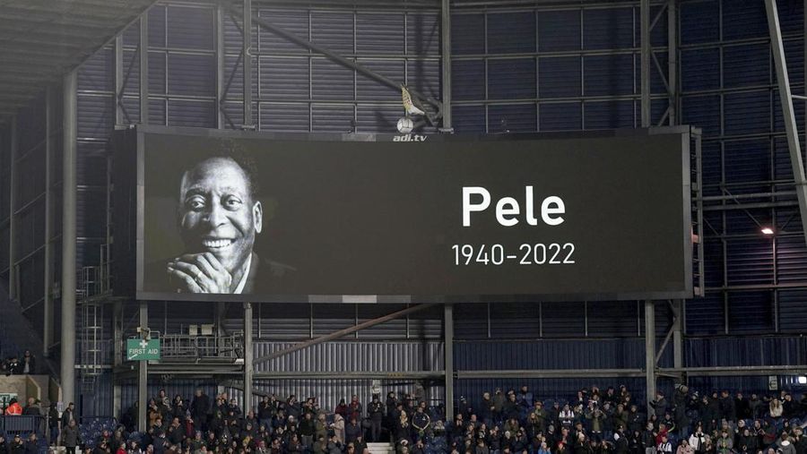 Seorang pengunjung melihat foto legenda sepak bola Brasil Edson Arantes do Nascimento 'Pele', dipamerkan di Pele Museum, di Santos, Brasil, pada 27 Desember 2022. (AFP via Getty Images/NELSON ALMEIDA)