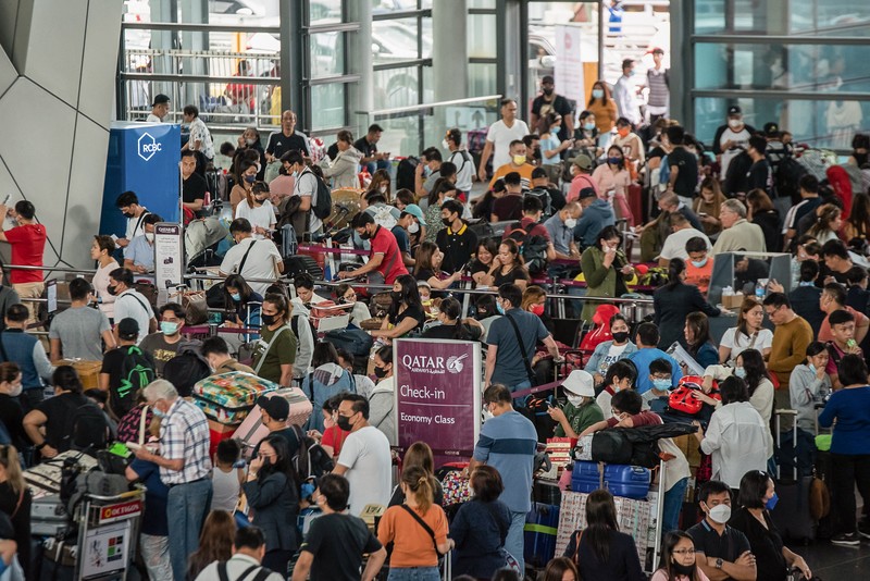1245918972 Passengers wait for information about their flights at terminal 3 of Ninoy Aquino International Airport in Pasay, Metro Manila on January 1, 2023. - Thousands of travellers were stranded at Philippine airports on January 1 after a