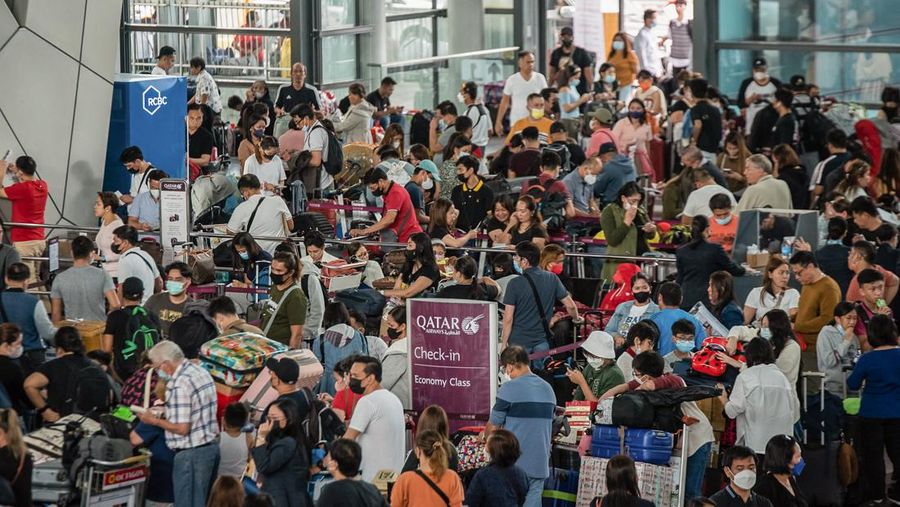 Passengers wait for information about their flights at terminal 3 of Ninoy Aquino International Airport in Pasay, Metro Manila on January 1, 2023. - Thousands of travellers were stranded at Philippine airports on January 1 after a 