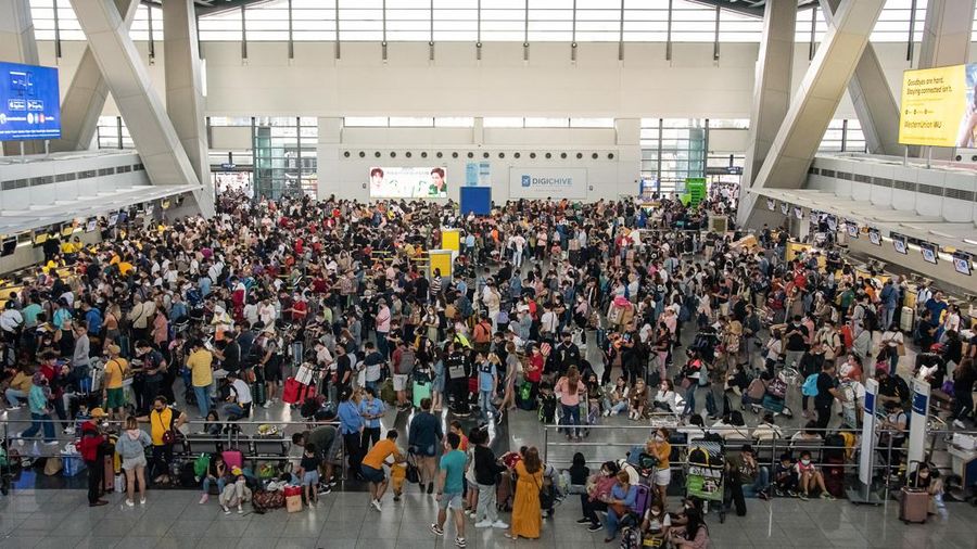 Passengers wait for information about their flights at terminal 3 of Ninoy Aquino International Airport in Pasay, Metro Manila on January 1, 2023. - Thousands of travellers were stranded at Philippine airports on January 1 after a