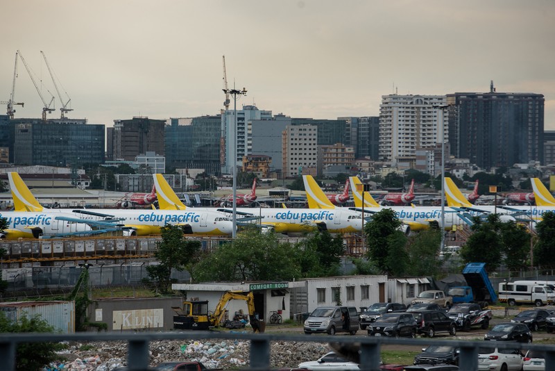 1245918972 Passengers wait for information about their flights at terminal 3 of Ninoy Aquino International Airport in Pasay, Metro Manila on January 1, 2023. - Thousands of travellers were stranded at Philippine airports on January 1 after a
