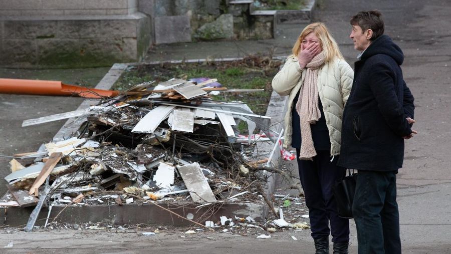 KYIV, UKRAINE - JANUARY 01: Local residents look at a residential building destroyed by a missile attack as Russia-Ukraine war continues in Kyiv, Ukraine on January 01, 2023. (Photo by Oleksii Chumachenko/Anadolu Agency via Getty Images)