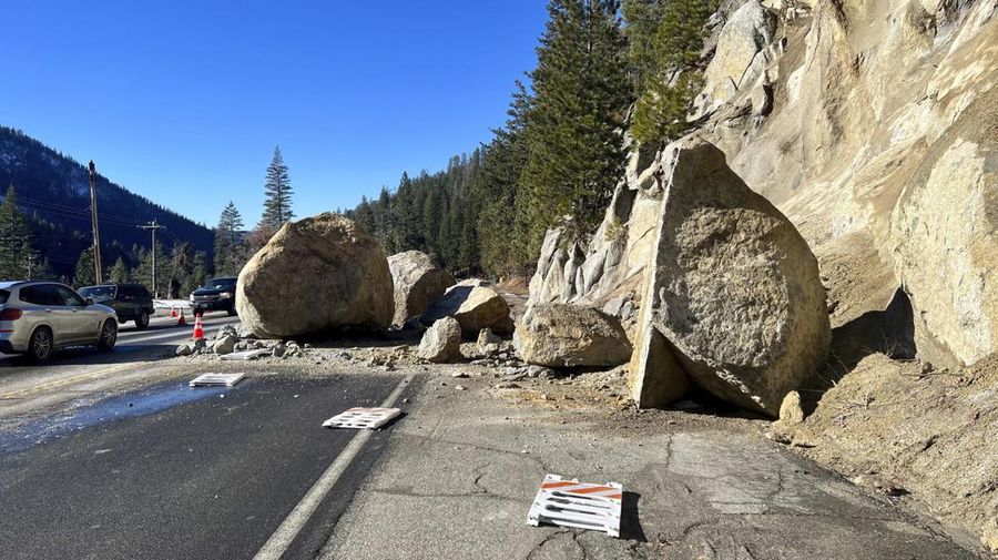 In this photo provided by Caltrans District 3, several large boulders lie in the street that fell onto Highway 50 just east of Kyburz during a storm in El Dorado National Park, Calif., Sunday, Jan. 1, 2023. Fortunately, no vehicles were hit. (Caltrans District 3 via AP)