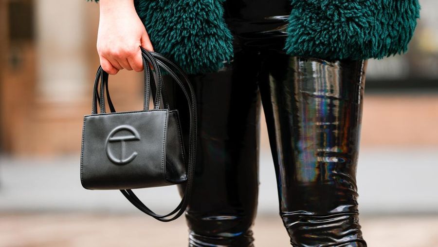 NEW YORK, NEW YORK - APRIL 23: Barber and Salon Stylist, Inessa Gurina, is seen wearing a green ASOS sherpa coat, black laced top, black leather pants, back heels accessorized with a small black Telfar shopping bag on April 23, 2021 in New York City. (Photo by Arturo Holmes/Getty Images)