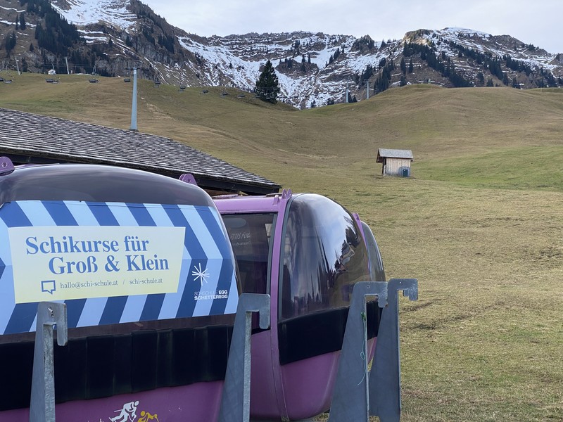 Skiers speed down a ski slope with artificial snow in the middle of a snowless field, at 1600 meters above sea level, in the alpine resort of Villars-sur-Ollon, Switzerland, Saturday, Dec. 31, 2022. Sparse snowfall and unseasonably warm weather in much of Europe is allowing green grass to blanket many mountaintops across the region where snow might normally be. It has caused headaches for ski slope operators and aficionados of Alpine white this time of year. (Laurent Gillieron/Keystone via AP)