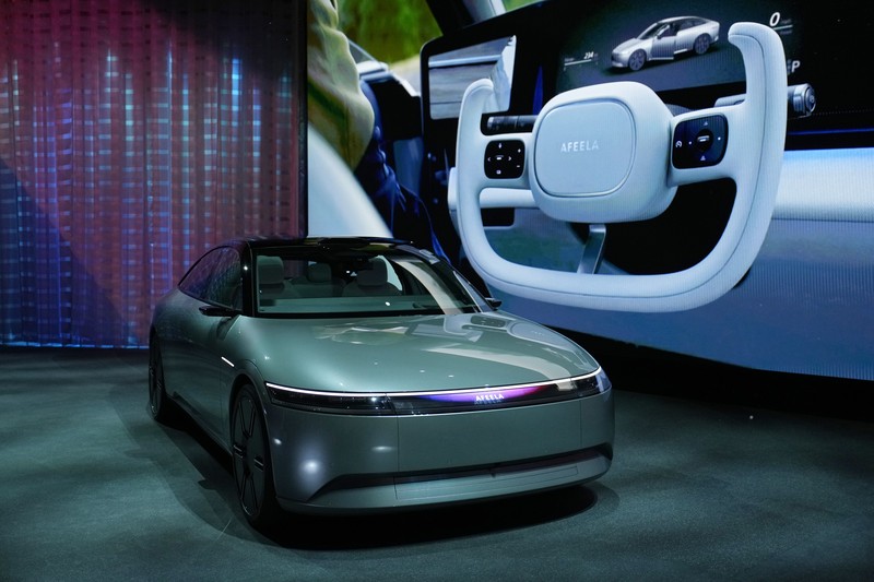 Gadget Show BMW Stella Clark of BMW AG, shows off the BMW i Vision Dee concept car that changes color during a pre-show keynote at CES 2023 Wednesday, Jan. 4, 2023, in Las Vegas. (AP Photo/Jack Dempsey)
