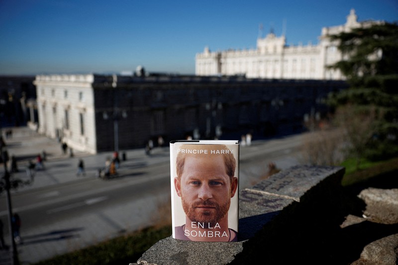 Spain Britain Prince Harry A woman poses for a photo as she opens a copy of