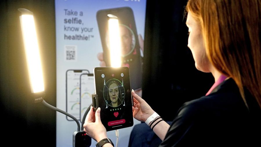 The Anura Lite is demonstrated at the Nuralogix booth during CES Unveiled ahead of the CES tech show, Tuesday, Jan. 3, 2023, in Las Vegas. The application uses a 30-second video selfie to capture facial blood flow patterns, which are used to output medical-grade health and vital sign measurements. (AP Photo/Rick Bowmer)