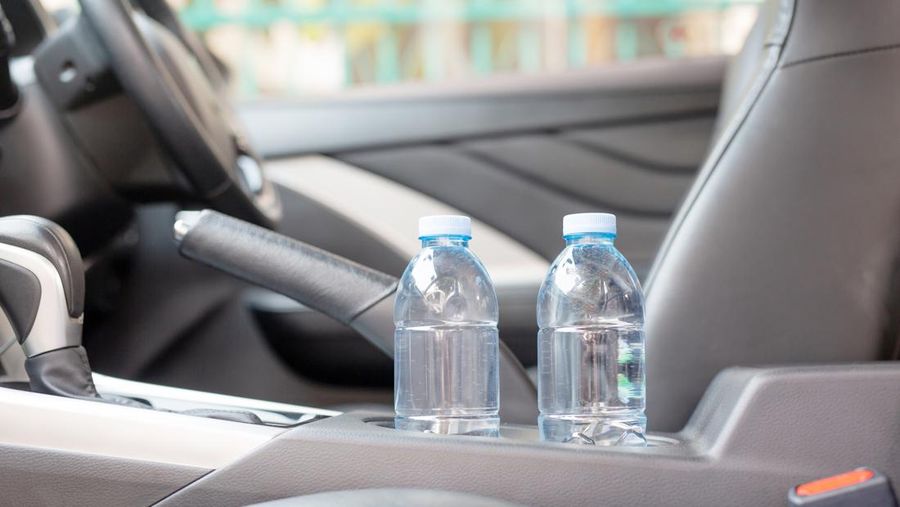 Drinking water in the car prepared for traveling