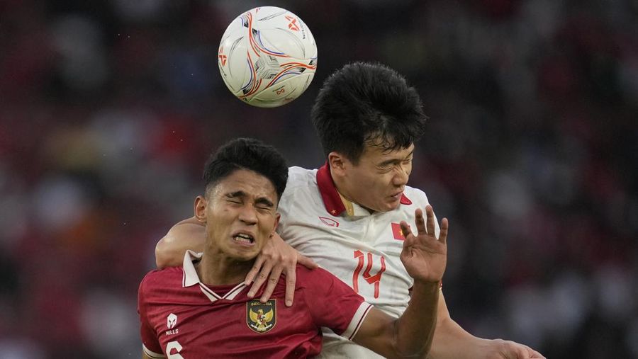Vietnam's Phan Van Duc, left, battles for the ball against Indonesia's Rachmat Irianto during their first leg of ASEAN Football Federation (AFF) Cup 2022 semifinal soccer match at Gelora Bung Karno Main Stadium in Jakarta, Indonesia, Friday, Jan. 6, 2023. (AP Photo/Achmad Ibrahim)