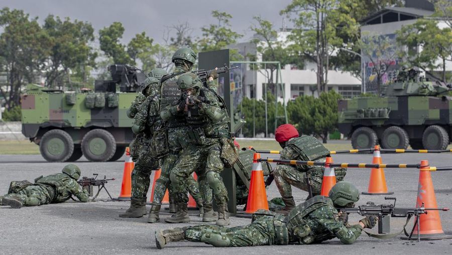 In this photo released by the Taiwan Presidential Office, soldiers take part in a drill during a visit by Taiwan's President Tsai Ing-wen, at a military base in Chiayi in southwestern Taiwan, Friday, Jan. 6, 2023. President Tsai visited a military base Friday to observe drills while rival China protested the passage of a U.S. Navy destroyer through the Taiwan Strait, as tensions between the sides showed no sign of abating in the new year. (Taiwan Presidential Office via AP)