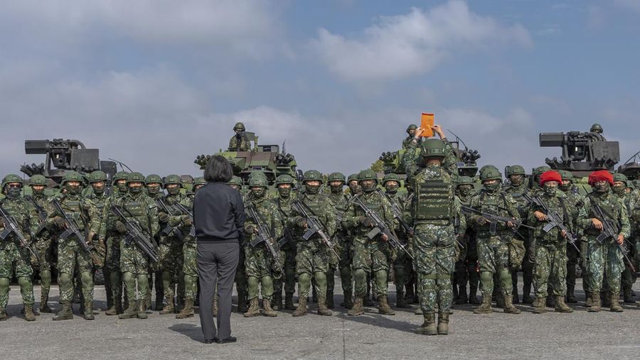 In this photo released by the Taiwan Presidential Office, Taiwan's President Tsai Ing-wen, foreground left, meets with soldiers at a military base in Chiayi, southwestern Taiwan, Friday, Jan. 6, 2023. President Tsai visited a military base Friday to observe drills while rival China protested the passage of a U.S. Navy destroyer through the Taiwan Strait, as tensions between the sides showed no sign of abating in the new year. (Taiwan Presidential Office via AP)