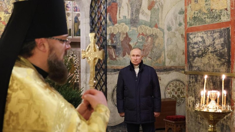 Russian President Vladimir Putin, background center, attends the Christmas service at the Annunciation Cathedral in the Moscow Kremlin in Moscow, Russia, Saturday, Jan. 7, 2023. Orthodox Christians celebrate Christmas on Jan. 7, in accordance with the Julian calendar. (Mikhail Klimentyev, Sputnik, Kremlin Pool Photo via AP)