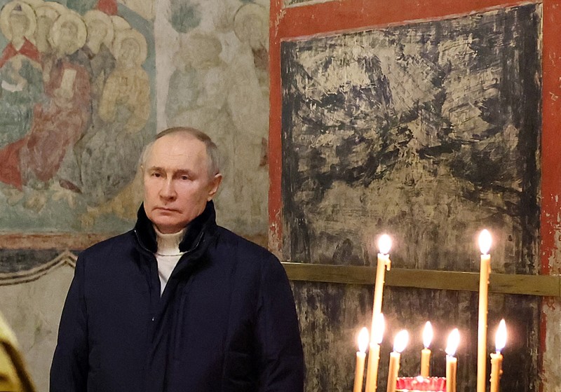 Russian President Vladimir Putin, background center, attends the Christmas service at the Annunciation Cathedral in the Moscow Kremlin in Moscow, Russia, Saturday, Jan. 7, 2023. Orthodox Christians celebrate Christmas on Jan. 7, in accordance with the Julian calendar. (Mikhail Klimentyev, Sputnik, Kremlin Pool Photo via AP)