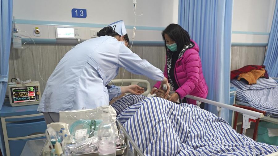 In this photo released by Xinhua News Agency, a wounded person receives medical treatment at a hospital following a traffic accident in Nanchang County in east China's Jiangxi Province, Sunday, Jan. 8, 2023. A traffic accident in southern China killed more than a dozen people and injured more people early Sunday as the annual Lunar New Year holiday travel rush got underway, authorities said. (Wan Xiang/Xinhua via AP)