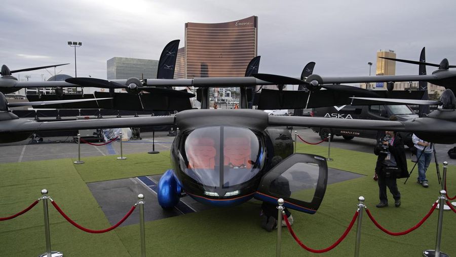 Stella Clark of BMW AG, shows off the BMW i Vision Dee concept car that changes color during a pre-show keynote at CES 2023 Wednesday, Jan. 4, 2023, in Las Vegas. (AP Photo/Jack Dempsey)