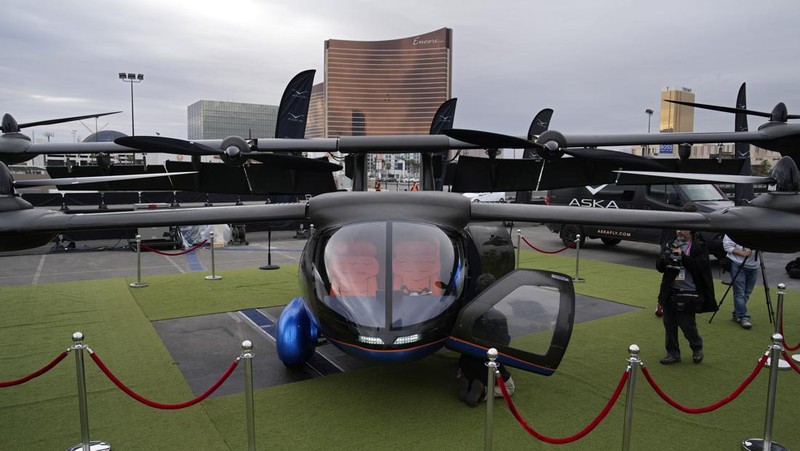 Stella Clark of BMW AG, shows off the BMW i Vision Dee concept car that changes color during a pre-show keynote at CES 2023 Wednesday, Jan. 4, 2023, in Las Vegas. (AP Photo/Jack Dempsey)