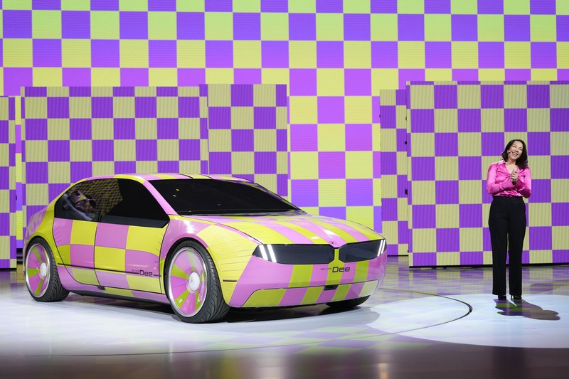 Stella Clark of BMW AG, shows off the BMW i Vision Dee concept car that changes color during a pre-show keynote at CES 2023 Wednesday, Jan. 4, 2023, in Las Vegas. (AP Photo/Jack Dempsey)