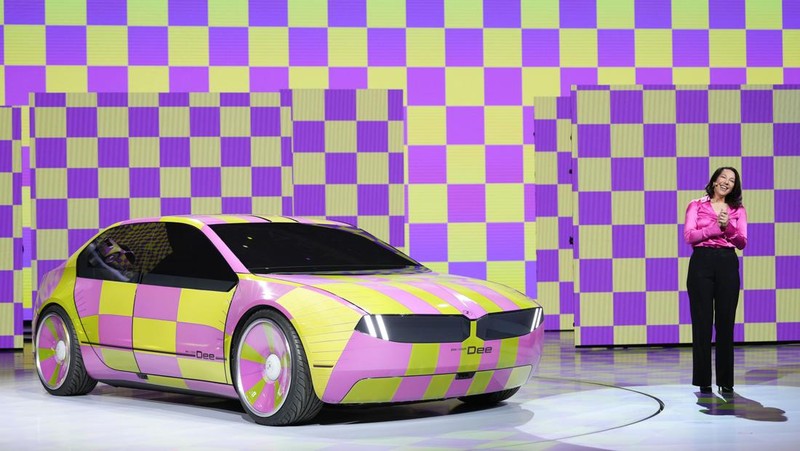 Stella Clark of BMW AG, shows off the BMW i Vision Dee concept car that changes color during a pre-show keynote at CES 2023 Wednesday, Jan. 4, 2023, in Las Vegas. (AP Photo/Jack Dempsey)