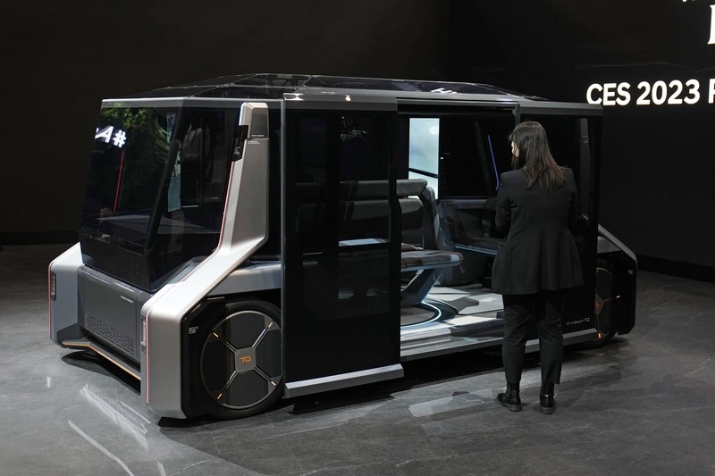 Stella Clark of BMW AG, shows off the BMW i Vision Dee concept car that changes color during a pre-show keynote at CES 2023 Wednesday, Jan. 4, 2023, in Las Vegas. (AP Photo/Jack Dempsey)