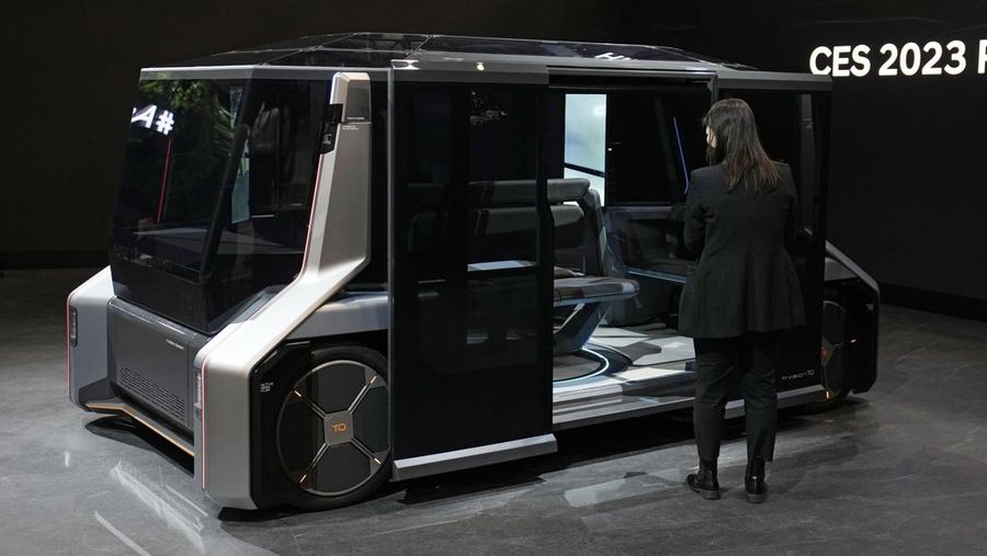Stella Clark of BMW AG, shows off the BMW i Vision Dee concept car that changes color during a pre-show keynote at CES 2023 Wednesday, Jan. 4, 2023, in Las Vegas. (AP Photo/Jack Dempsey)