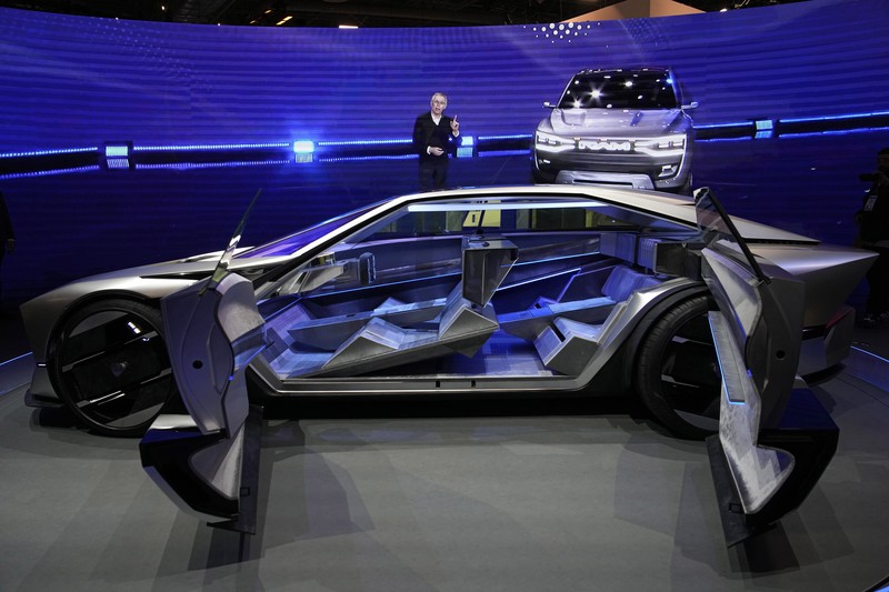 Stella Clark of BMW AG, shows off the BMW i Vision Dee concept car that changes color during a pre-show keynote at CES 2023 Wednesday, Jan. 4, 2023, in Las Vegas. (AP Photo/Jack Dempsey)
