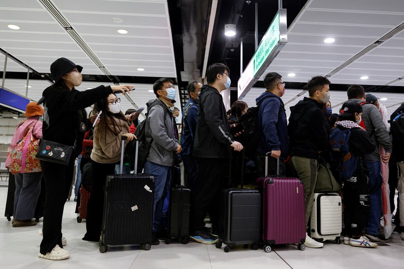 Travellers arrive at Hong Kong's Lok Ma Chau border checkpoint on the first day China reopens the border amid the coronavirus disease (COVID-19) pandemic in Hong Kong, China, January 8, 2023. REUTERS/Tyrone Siu