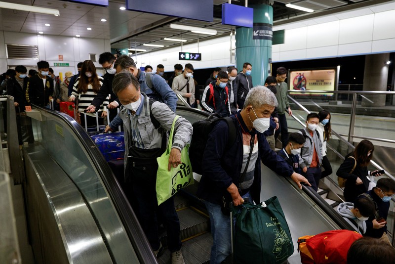Travellers arrive at Hong Kong's Lok Ma Chau border checkpoint on the first day China reopens the border amid the coronavirus disease (COVID-19) pandemic in Hong Kong, China, January 8, 2023. REUTERS/Tyrone Siu