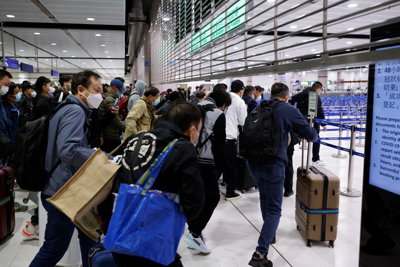 Travellers arrive at Hong Kong's Lok Ma Chau border checkpoint on the first day China reopens the border amid the coronavirus disease (COVID-19) pandemic in Hong Kong, China, January 8, 2023. REUTERS/Tyrone Siu