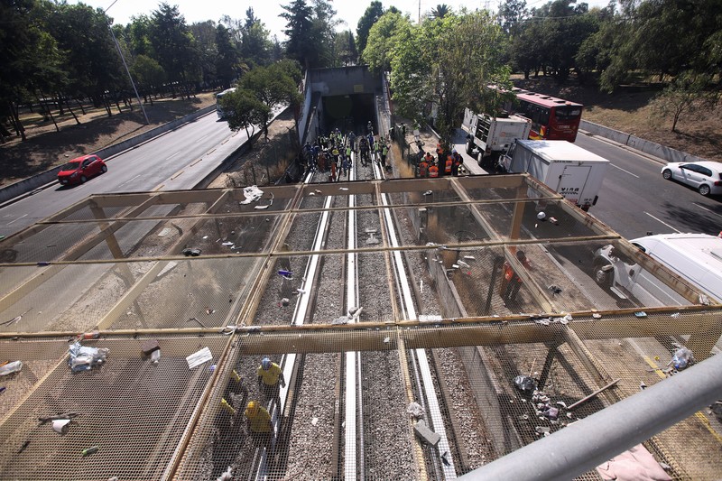 Rescue personnel work near the area where two subway trains collide head-on at a subway station, in Mexico City, Mexico, January 7, 2023. REUTERS/Quetzalli Nicte-Ha