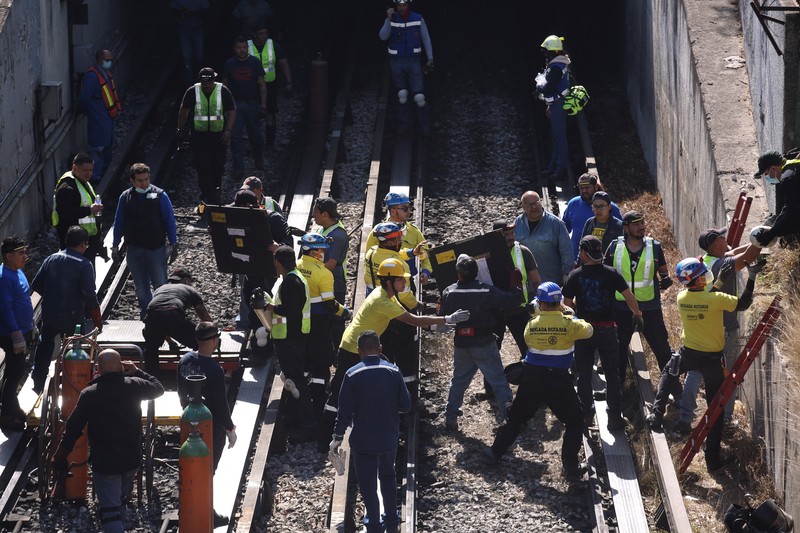 Rescue personnel work near the area where two subway trains collide head-on at a subway station, in Mexico City, Mexico, January 7, 2023. REUTERS/Quetzalli Nicte-Ha