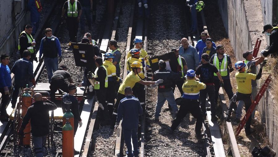 Rescue personnel work near the area where two subway trains collide head-on at a subway station, in Mexico City, Mexico, January 7, 2023. REUTERS/Quetzalli Nicte-Ha
