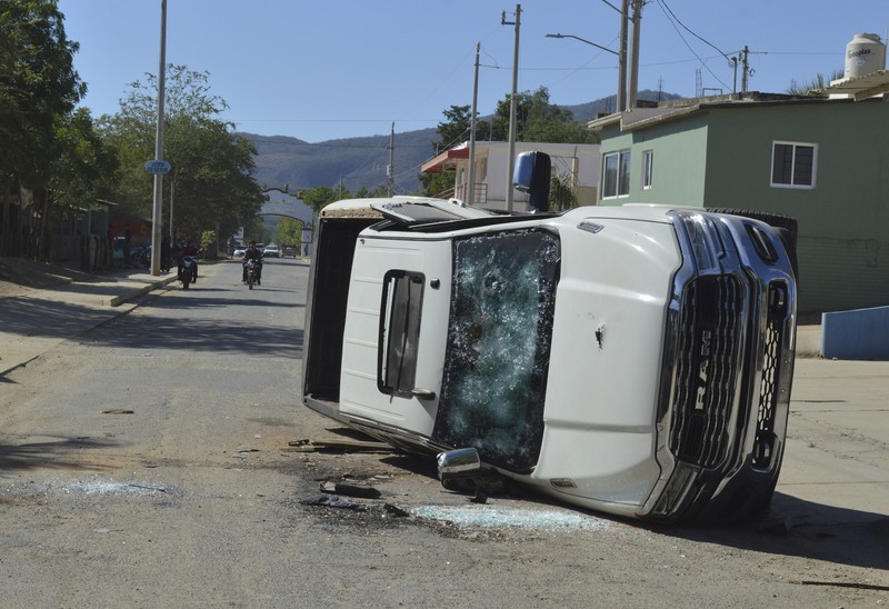 Mexico Violence A vehicle riddled with bullets lies overturned on a street in Jesus Maria, Mexico, on Saturday, Jan. 7, 2023, the small town where Ovidio Guzman was detained earlier in the week. Thursday's government operation to detain Ovidio, the son of imprisoned drug lord Joaquin