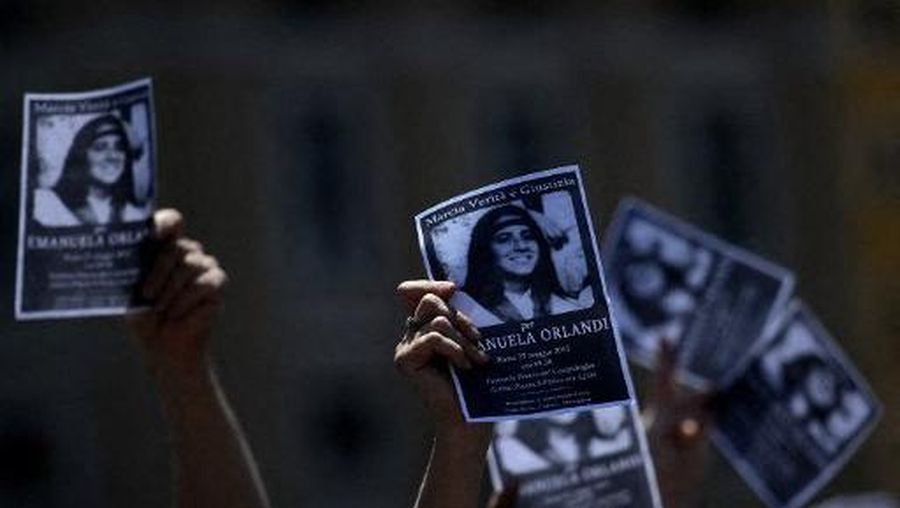 A demonstrator holds a poster of Emanuela Orlandi reading
