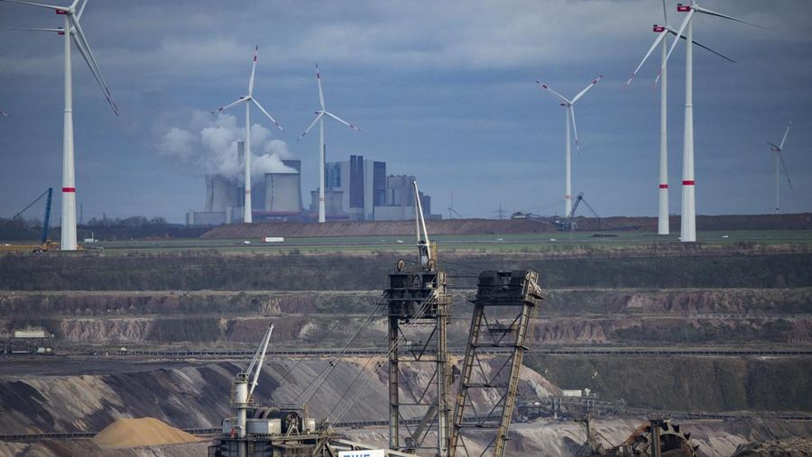 A view of the opencast mining area near Lützerath, the Niederaussem coal-fired power plant can be seen in the background, in Erkelenz, Germany, Sunday, Jan. 15, 2023. Police say that a village in western Germany that is due to be demolished to allow the expansion of a coal mine has been cleared of activists, apart from a pair who remain holed up in a tunnel. The operation to evict climate activists who were holed up in the hamlet of Luetzerath kicked off on Wednesday morning and progressed steadily over the following days. (Thomas Banneyer/dpa via AP)