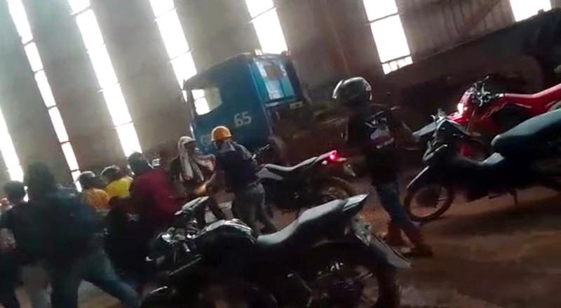 Employees react amid the chaos as Chinese and Indonesian workers clash at a nickel smelter in Morowali, Sulawesi, Indonesia in this undated social media video released January 16, 2023. Revi Limbong via REUTERS THIS IMAGE HAS BEEN SUPPLIED BY A THIRD PARTY. MANDATORY CREDIT
