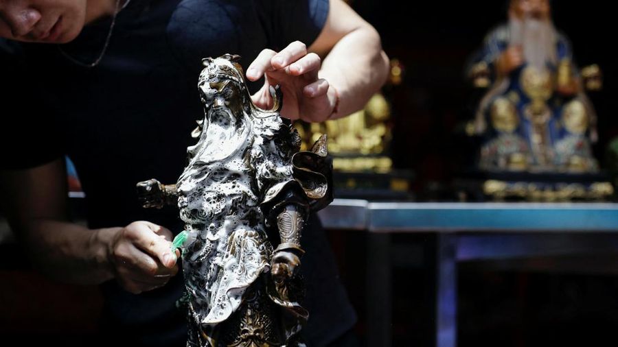 Worshipers clean the sacred figures as they prepare for the Lunar New Year celebrations, at Dhanagun temple in Bogor, West Java province, Indonesia, January 16, 2023. REUTERS/Willy Kurniawan