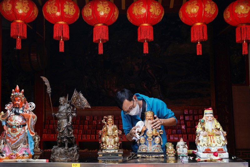 Worshipers clean the sacred figures as they prepare for the Lunar New Year celebrations, at Dhanagun temple in Bogor, West Java province, Indonesia, January 16, 2023. REUTERS/Willy Kurniawan