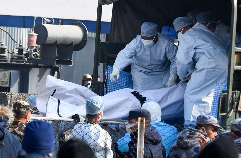 NEPAL-CRASH/ A rescue team recovers the bodies of victims from the site of the plane crash of a Yeti Airlines-operated aircraft, in Pokhara, Nepal January 16, 2023. REUTERS/Sulav Shrestha NO RESALES. NO ARCHIVES REFILE - CORRECTING THE NUMBER OF BODIES TPX IMAGES OF THE DAY