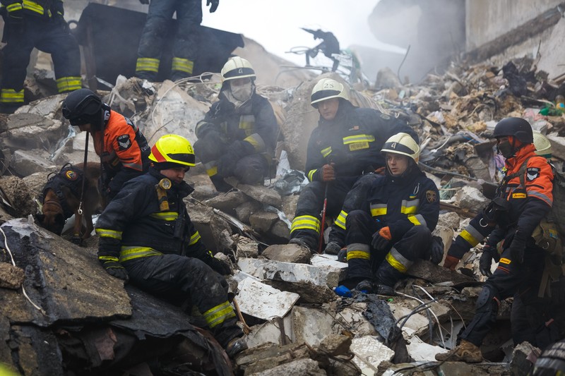 1456795838 DNIPRO, UKRAINE - JANUARY 15: Rescuers search people trapped under the rubble of a high-rise residential building hit by a missile on January 15, 2023 in Dnipro, Ukraine. On January 14, Russia launched a new massive attack on Ukrainian cities. In Dnipro, one of the Х-22 cruise missiles hit a nine-story residential building, completely destroying one of the sections from top to bottom floors. The number of dead has increased to 29 people, with rescue work continuing. More than 40 residents of the building are still being searched. (Photo by Yurii Stefanyak/Global Images Ukraine via Getty Images)