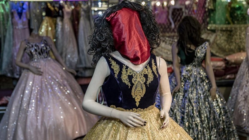 A mannequin's head is covered in a woman dress shop in Kabul, Afghanistan, Monday, Dec. 26, 2022. Under the Taliban, the mannequins in women's dress shops across the Afghan capital Kabul are a haunting sight, their heads cloaked in cloth sacks or wrapped in black plastic bags. The hooded mannequins are one symbol of the Taliban's puritanical rule over Afghanistan (AP Photo/Ebrahim Noroozi)