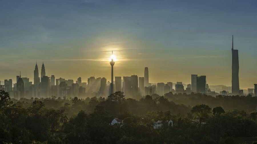 The sun rises behind Kuala Lumpur Tower in the morning in Kuala Lumpur, Malaysia, Tuesday, Jan. 17, 2023. (AP Photo/Vincent Thian)