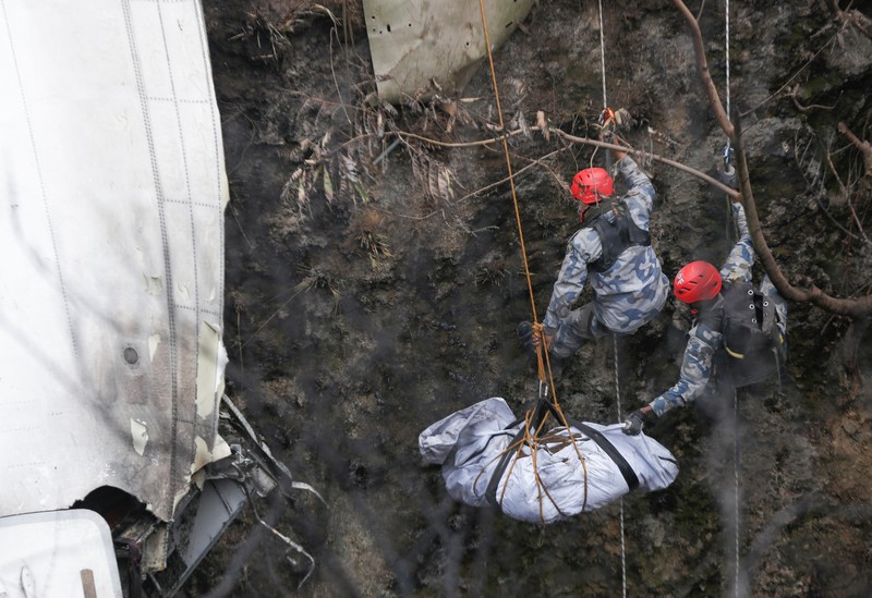 A rescue team recovers the bodies of victims from the site of the plane crash of a Yeti Airlines-operated aircraft, in Pokhara, Nepal January 16, 2023. REUTERS/Sulav Shrestha NO RESALES. NO ARCHIVES  REFILE - CORRECTING THE NUMBER OF BODIES    TPX IMAGES OF THE DAY